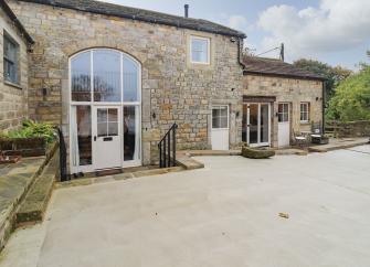 A large bArn conversion in Pateley Bridge with a central 2-storey arched window.