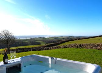 A hot tub with views across open countryside.
