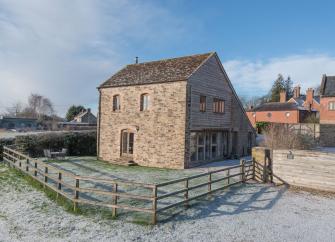 A contemporary 2-storey Ludlow holiday cottage with a courtyard and lawn.