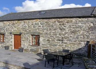 A long, stone-built, single storey, courtyard barn conversion in Gwynedd