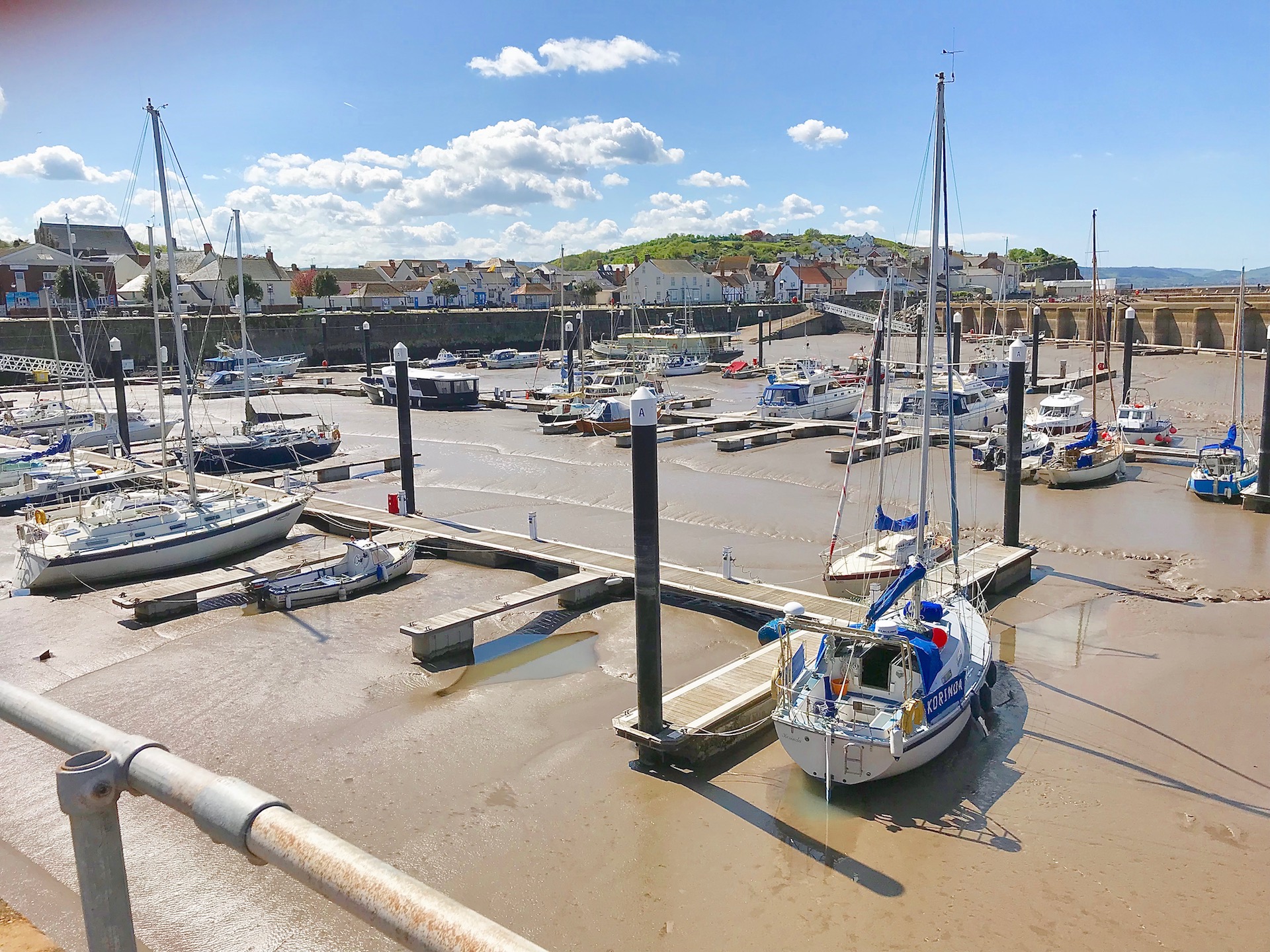 watchet harbour at low tide..Small fishing boats and yachts are settled on the sandy harbour floor.