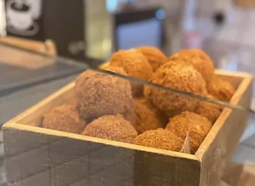 Scotch eggs clustered together in a wooden box