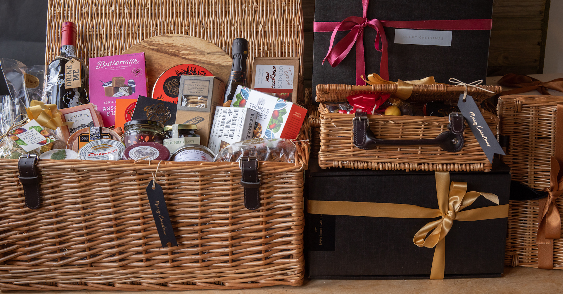 wiicker hampers filled with packets and jars of luxury food items.