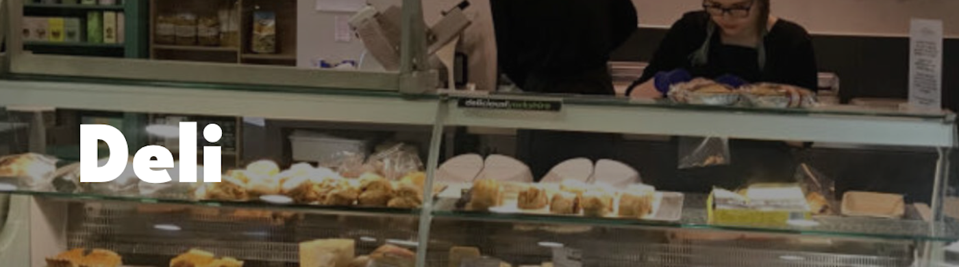 front counter of Cedra Barn Deli with a glass case filled with cheeses and pies