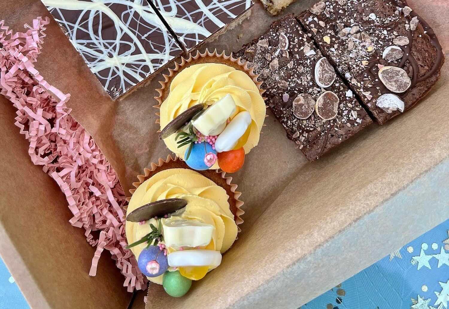 Small icing covered cakes in a box