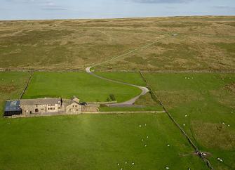 A small Pennine hillside  farmhouse and outbuildings in a remote location 