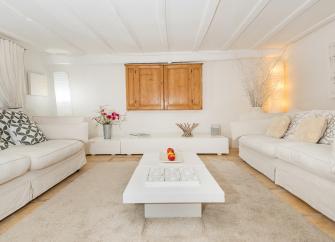 An luxury eco cottage lounge, with soft furnishings all in white