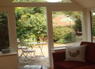 The terrace seen through French windows in the lounge at The Little Bothy.