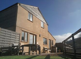 A 2-storey Dorset mill conversion overlooks a terrace and lawned garden.