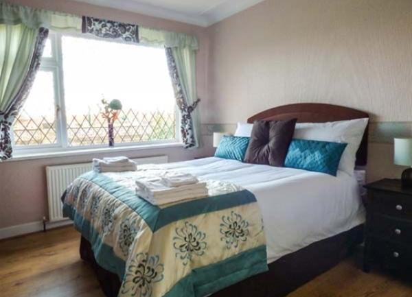 Double bedroom with twin bedside cabinets and table lights.
