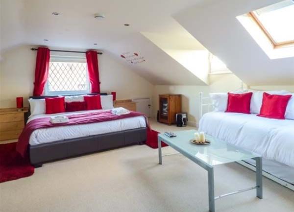 Doublke bedroom with double bed, a day bed and coffee table.