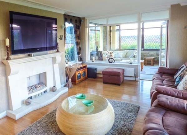 An open plan, pine-floored lounge area.