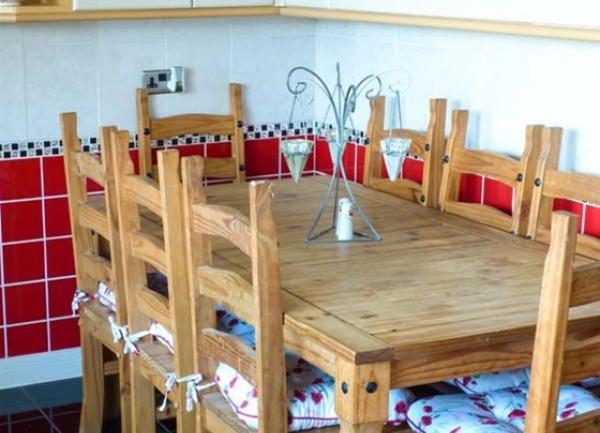 A pine breakfast table for 8 a kitchen.