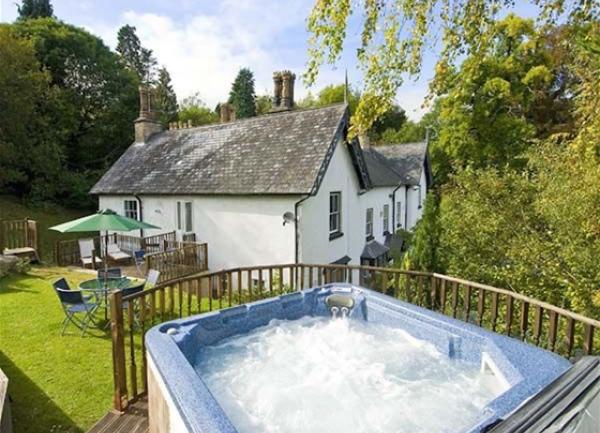 A hot tuub on a raised terrace enjoys views of the garden and the Manor House.