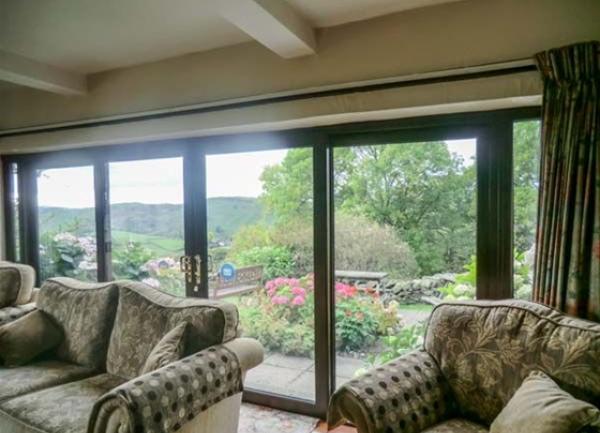 Garden and rural view through glass sliding doors in the lounge.