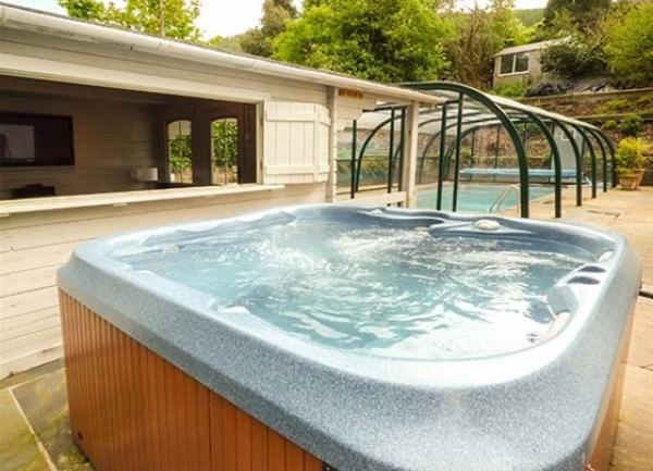 A patio hot tub next to a swimming pool.