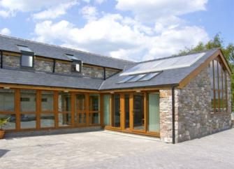 A contemporary cottage with floor-to-ceiling windows facing a courtyard