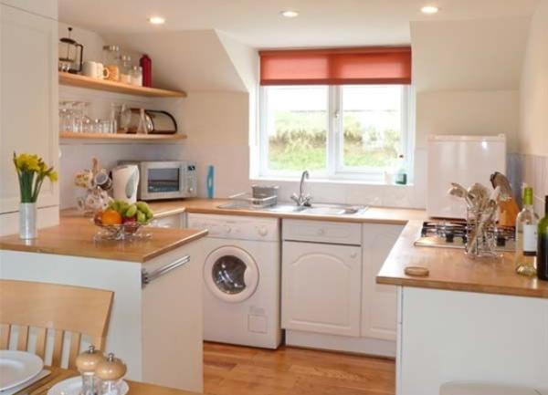 S fitted kitchen with pine worktops, fridge, microwave and washing machine