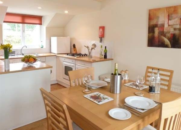 Kitchen-diner with a dining table laid for tea.