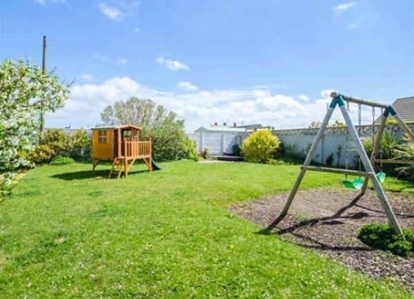Chiildrens swing and cabin. on a large secure lawn.