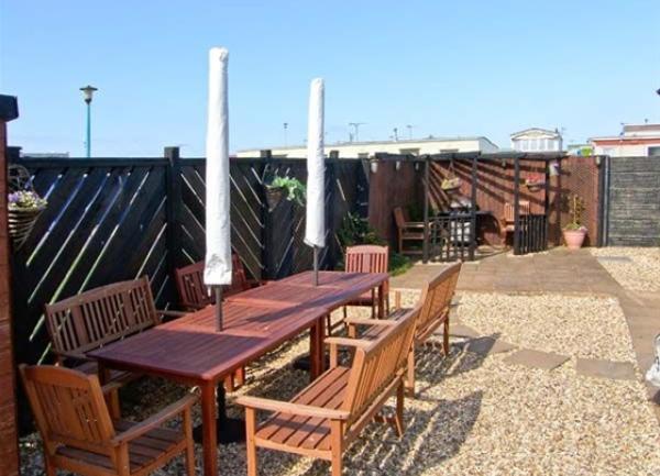 Shingle terrace with outdoor dining furniture.