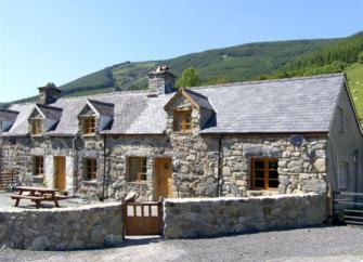 A large stone-built barn conversion in a remote rural setting.