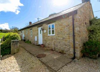 Stone-built, single storey barn conversion overlooking open countryside.