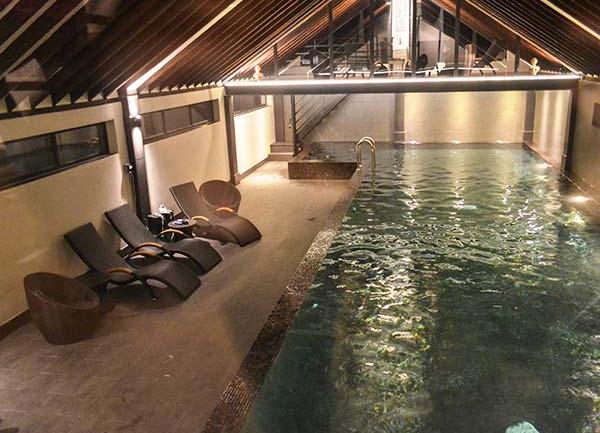A swimming pool lit up at night.