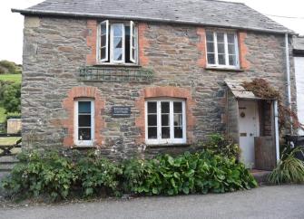 Exterior of a stone-built riverside cottage on Exmoor