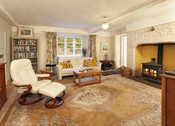 Cottage lounge with inglenook fireplace and wood burner.