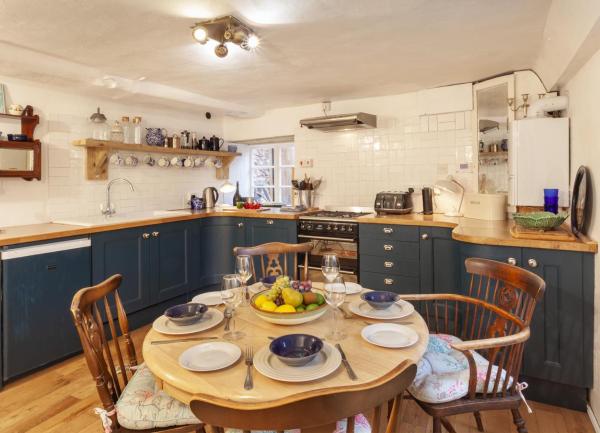 cottage kitchen with fitted units and dining table for eight