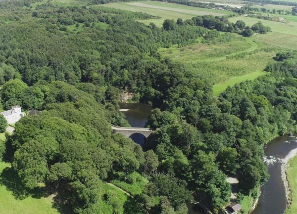 Aerial view of a wooded river valley.