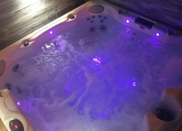 Underwater lights shone in a hot tub at night.