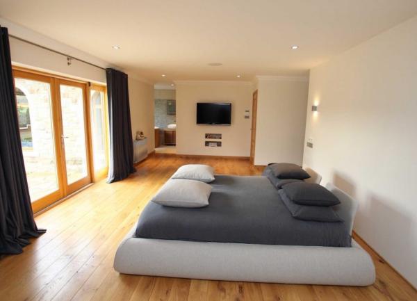 Double bedroom with TV and French windows.