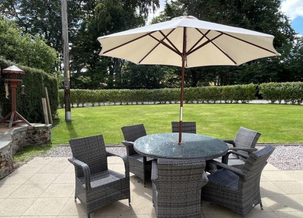 Garden patio with outdoor dining furniture.