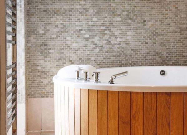 Wood panelled indoor hot tub.