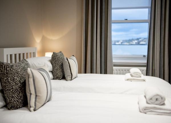 Double bed with cushions and towel sets.