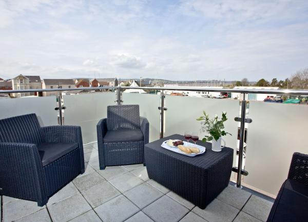 Outdoor easy chairs and table on an Exmouth roof terrace.