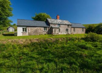 Exterior of a stone-built Exmoor farmhouse standing ina.  remote moorland location