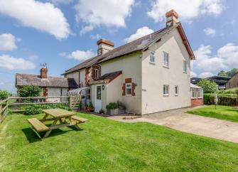 Exterior of a 1930s Dorset house and garden in Dorset with a large lawn