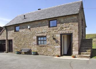 2-storey exterior of a stone-built Peak District holiday cottage in a remote rural location.