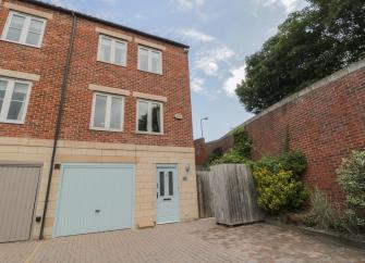 3-storey exterior of a Whitby holiday home with a garage on the ground floor