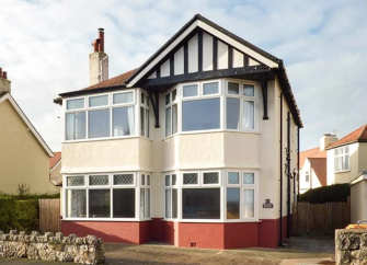 Exterior of a 1930s beach front house in Rhos-on-Sea with a mock-Gothic gable end
