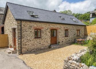 A stone barn conversion with velux windows in the roof and surrounded by a courtyard in the North Devon countrysidecountry