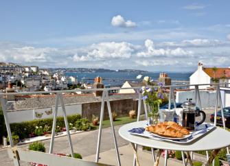 Sea view from a patio with a breakfast table