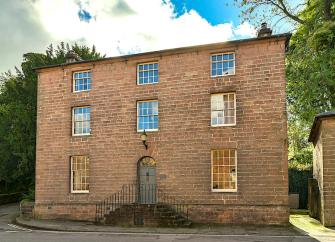 A 3-storey Georgian house with sash windows.