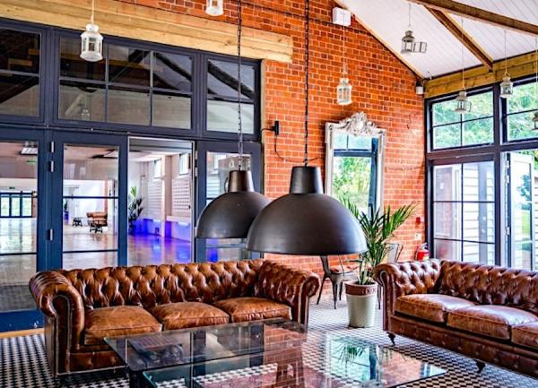 Large club lounge with leather sofas and glass-topped tables.