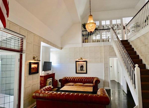 Lounge with leather sofas and TV.