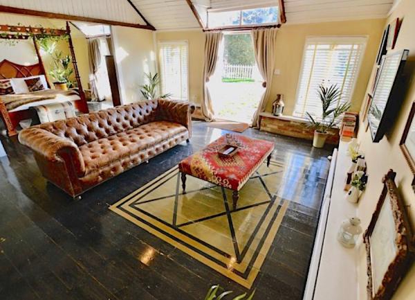 Holiday cottage lounge on Osea Island with padded leather sofa