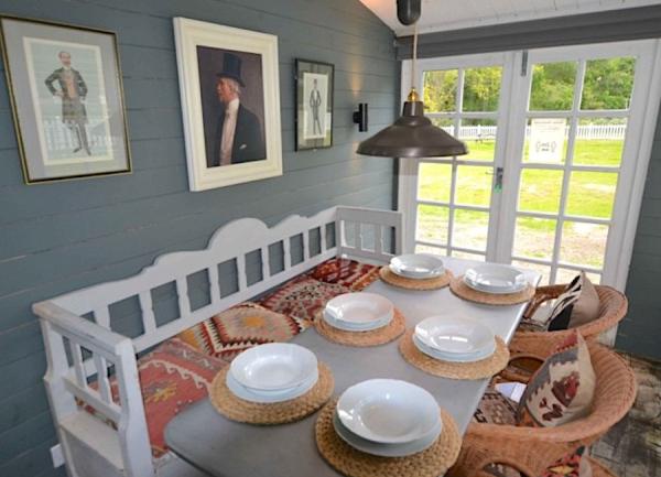 Dining room with French windows and table laid for 6.